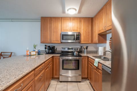 Large island with barstools for dining options.