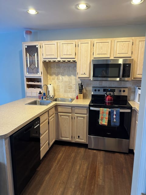 Kitchen with dishwasher, stove, microwave, double sink (& garbage disposal)