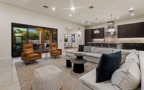 Open-concept great room w/ soaring ceilings, custom cabinets, & modern touches.