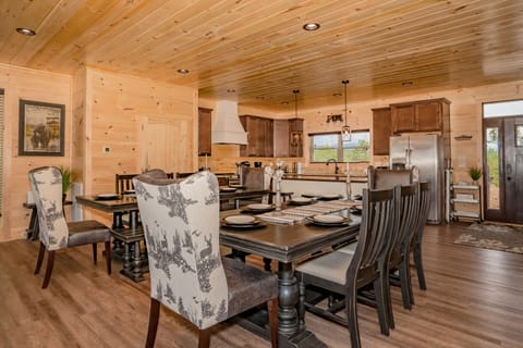 Two kitchen tables that seat at least 18 with additional seating on bar stools.