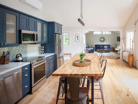 The huge  kitchen has big doors to the porch deck and is open to the living room
