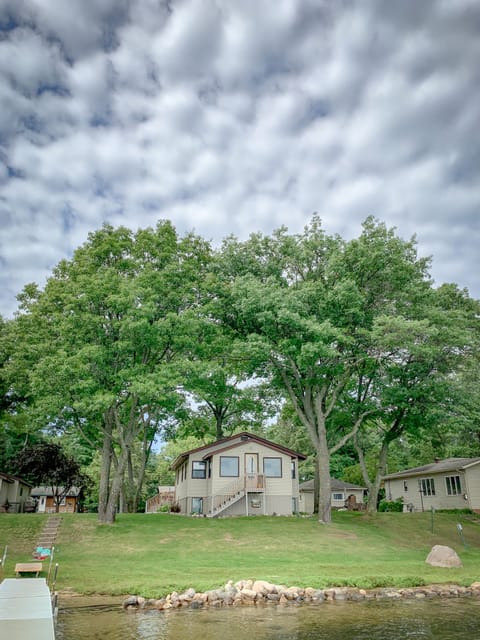 This is a view of the house from the lake in the summer. 