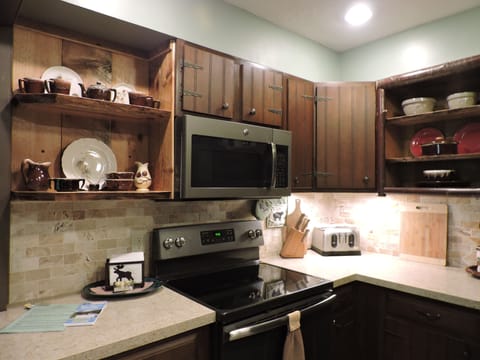 Ceramic top stove w/overhead microwave. 