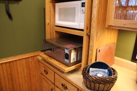 In the dining room, a pizza oven and  microwave.
