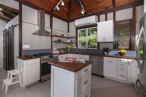 Kitchen, with pantry behind barn doors in background.