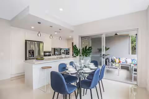 Dining for six by the kitchen, breakfast bar and covered balcony.