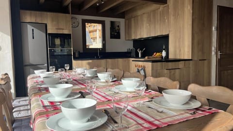 Large open plan living and dining area with views over the piste with floor to ceiling windows.