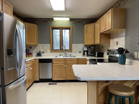 Abundantly stocked kitchen with new appliances and every imaginable gadget.