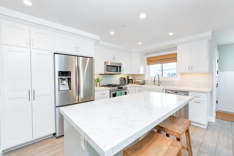 The spacious kitchen island with bar seating makes meal prep a social affair!
                