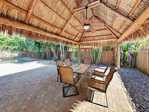Escape to a tropical island resort with your own tiki hut in the back yard
