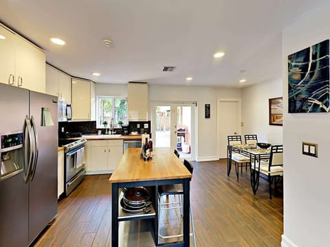 It’s easy for the chef to stay part of the conversation in the open-concept kitchen with all-white cabinetry and stainless steel appliances.