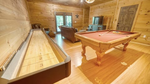 Game room with pool table, shuffle board, arcade games, and 50" smart tv