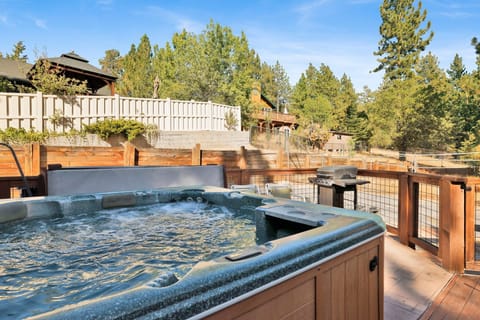 Enjoy breathtaking views while soaking in the hot tub, surrounded by serene ambiance and perfect for relaxation and memorable stays