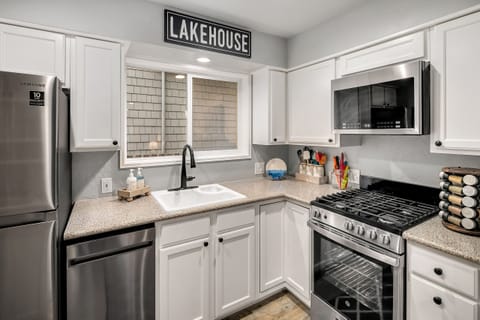 Kitchen with Stainless Steal Gas Stove, Oven, Microwave, Dishwasher and Frig