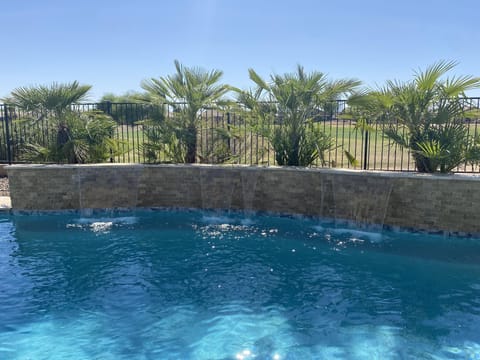 New Pool with 3 shear watefalls, wrap around seating and Baja shelf for umbrella