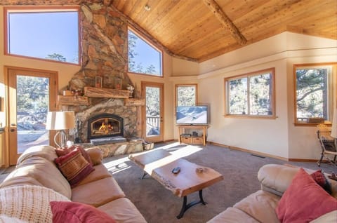 Living room with fireplace and flat-screen. Bar area with Keurig and a mini wine fridge.