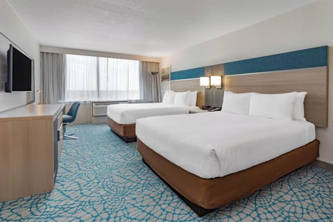 Unwind in bright comfort with two plush beds and sunshine.