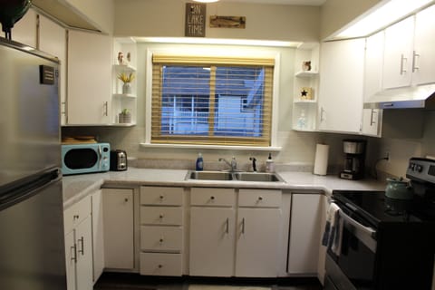 Fully stocked kitchen, with full size fridge and stove