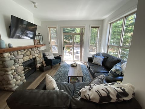 Spacious and bright living room looking out onto the walkout deck.