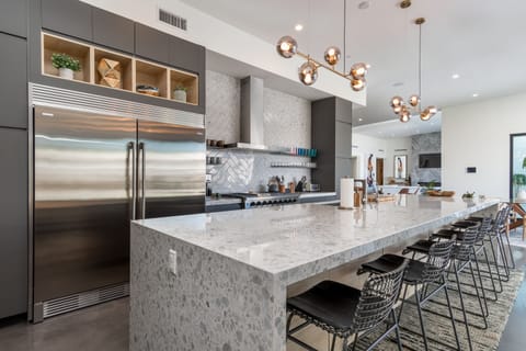 Kitchen has large six burner Thor range with double oven and spacious fridge