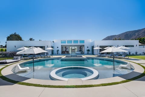 Submerged infinity edge hot tub with baja lounge on either side