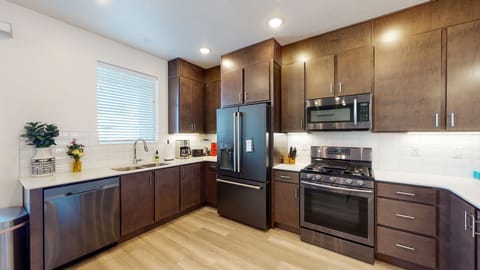 Spacious kitchen with upgraded fridge and full stocked kitchen and coffee bar.