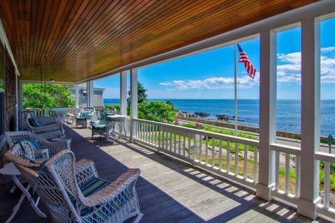 Large, wide porch with multiple seating and eating areas