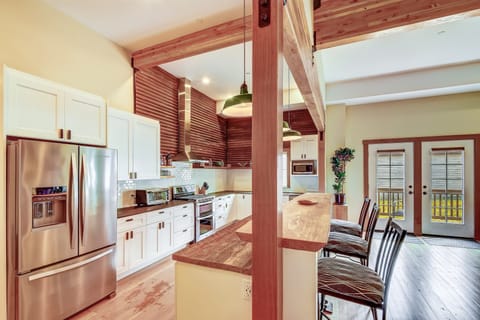 Industrial chef's kitchen complete with propane stove, stainless steel fridge and dishwasher