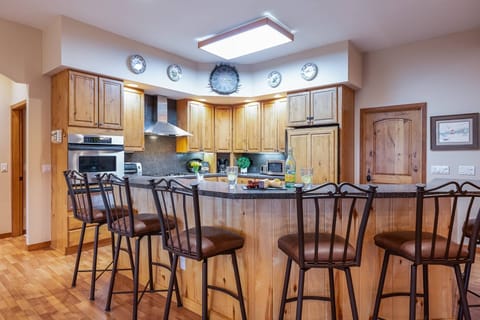 Casual bar dining or pull a chair up by the large family style table, either way there is room for all 12 guests in this open concept floorplan.