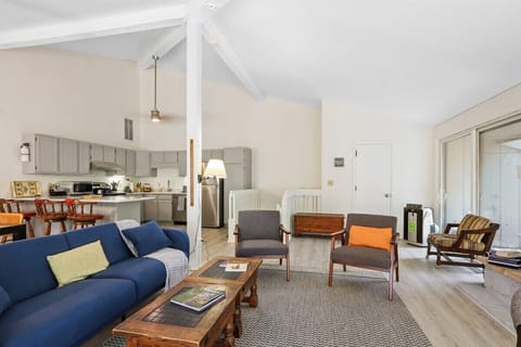 Open concept living room to kitchen and dining area with gas fireplace.