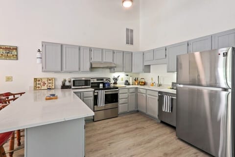 Electric stove, stainless steel appliances, and dishwasher.