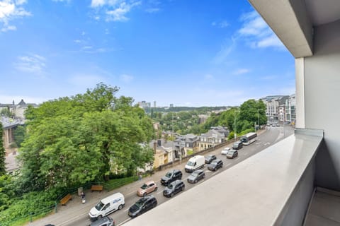 Wake up to vibrant city views from this cozy balcony – urban relaxation awaits!