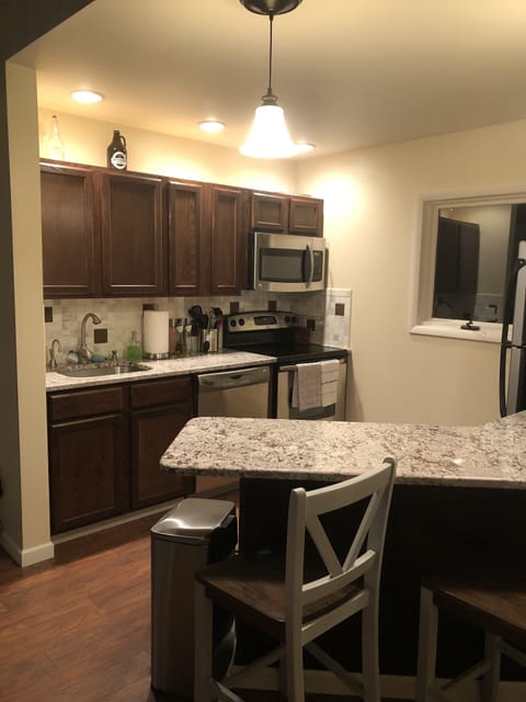 Updated stainless steel kitchen with granite breakfast bar
