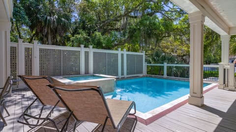 Outdoor pool with hot tub and lounge area