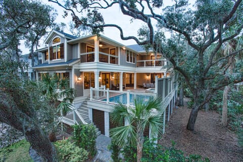 Multiple porches and balconies create inviting outdoor living spaces that overlook the private pool and spa, offering the perfect blend of serenity and resort-style comfort.