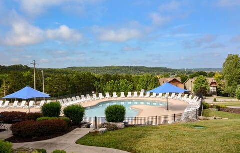 Clubhouse pool with lounge chairs and splash pad for kids.