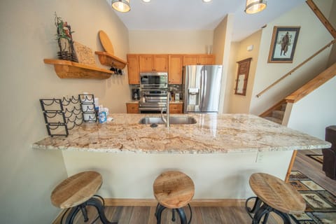 Updated granite countertops with bar stool seating