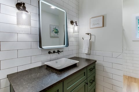 Main Level Bathroom w/ shower. Adjacent to King Bedroom #1. 