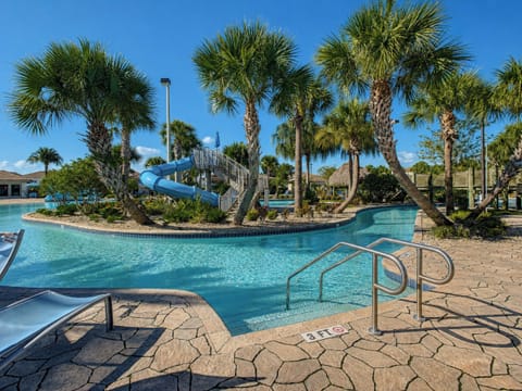 Resort Lazy River and Water Slide Surrounded by Palm Trees