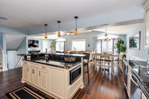 Kitchen has 2 sinks and wine refrigerator