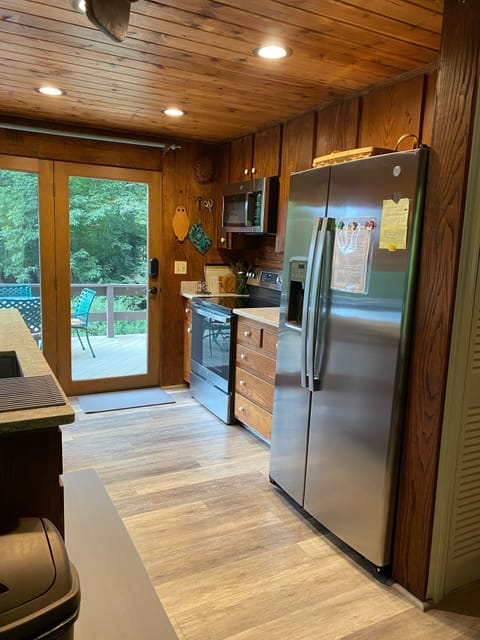 Deck access from remodeled kitchen w/ quartz counters & wormy chestnut cabinets 