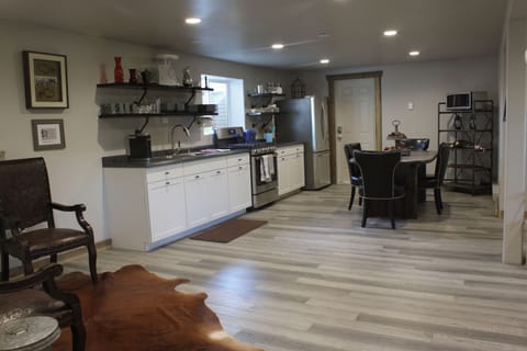 Kitchen and dining area with a peek of the sitting area to the left