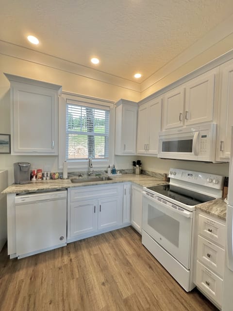 Kitchen stocked with cookware and assortment of spices.