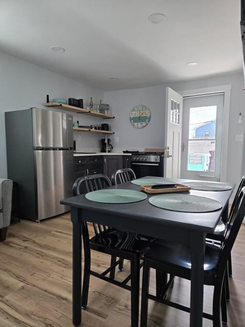 open concept kitchen/dining/living area with climate control and smart tv