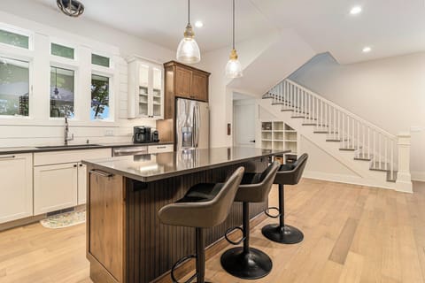 Gather round the quartz island featuring undermount microwave and 
seats for 3 