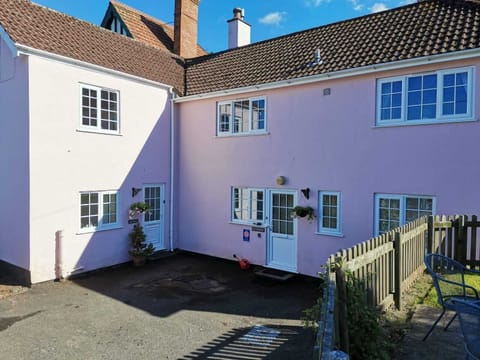 Front of house with car parking.  L