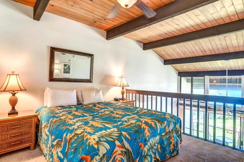 Wake up to soft light in this open-air loft bedroom with vaulted beams, lush views, and cozy island-style decor  