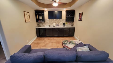 Downstairs wet bar, TV, couch, small fridge, laundry, half bath, Bedroom 3 King