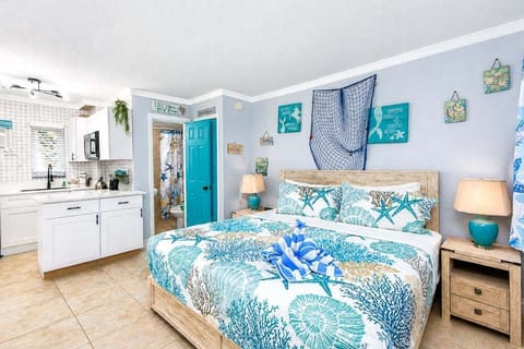 Freshly renovated ground-floor studio with a plush king bed, electric fireplace, and 50" smart TV — perfect for cozy nights in after a day at the beach. Open-concept kitchen and living space make this a bright, easy home base.