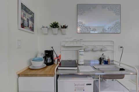 The small kitchenette has an induction cooktop, microwave, mini-fridge w/ freezer, and the essential pots and pans, olive oil salt and pepper.